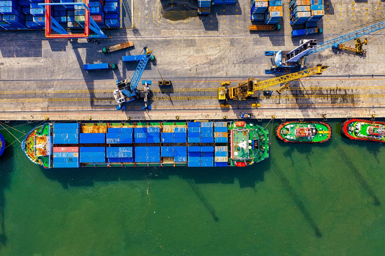 Aerial photograph showcasing vibrant cargo operations at a bustling port in North Jakarta, Indonesia.